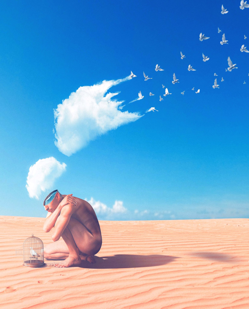 A man in the desert with clouds disapearing above him